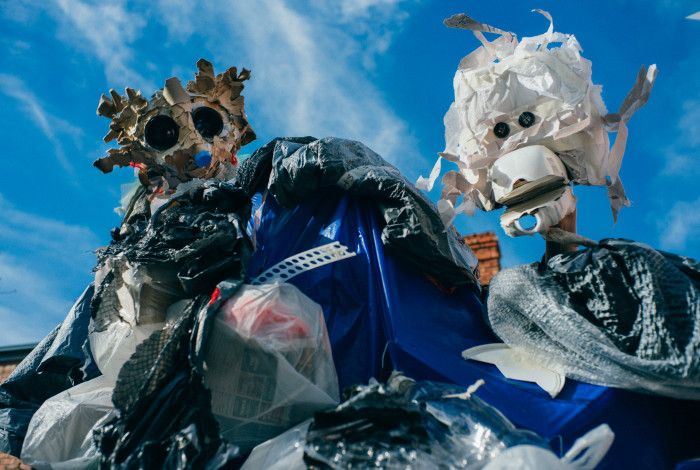 Cute puppets made from rubbish items, against a blue sky