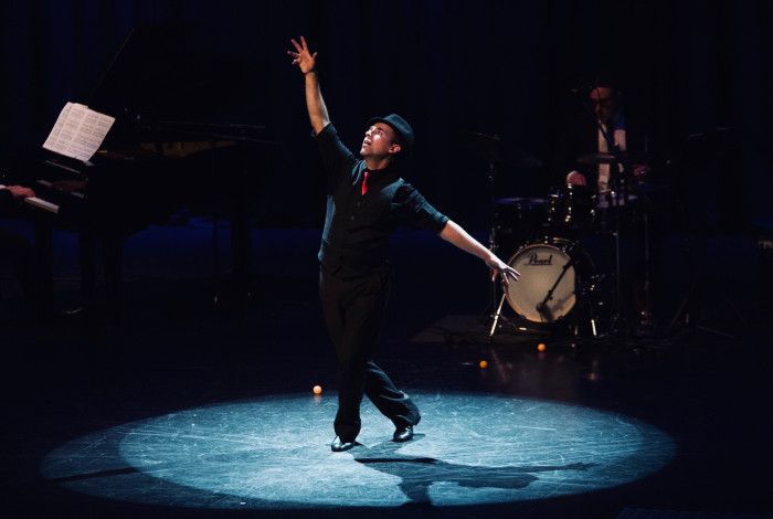 Person dancing under spotlight.