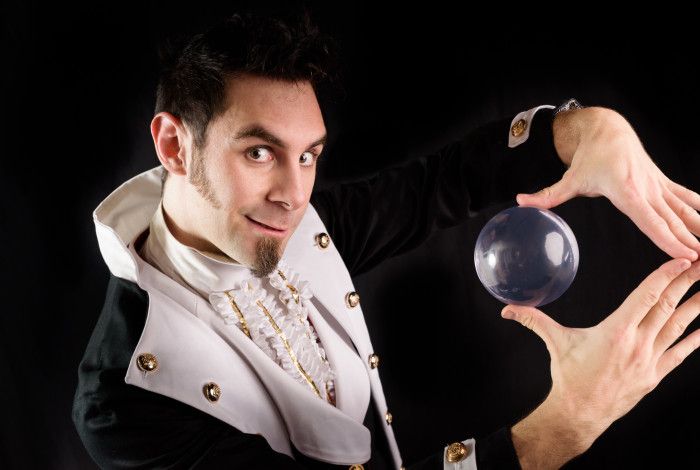 Quizzical Mr Jeff holding a crystal ball.