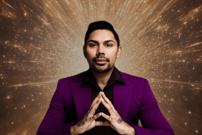 Cael O'Donnell, dressed in purple jacket, with his fingertips pressed together, against a cosmic brown-gold background