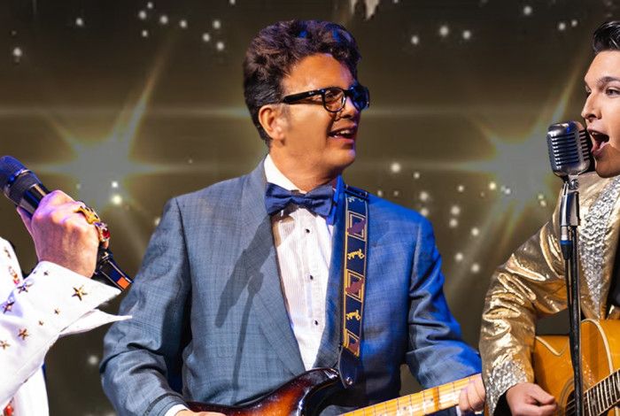 Elvis Presley and Buddy Holly tribute performers, in costume and performing on stage