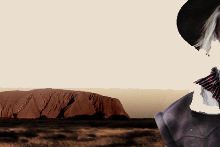 A man with Uluru in the background