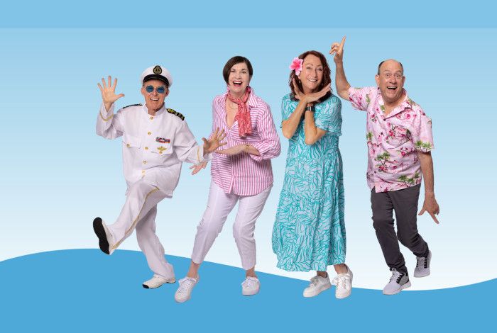 Four people laughing and dancing
