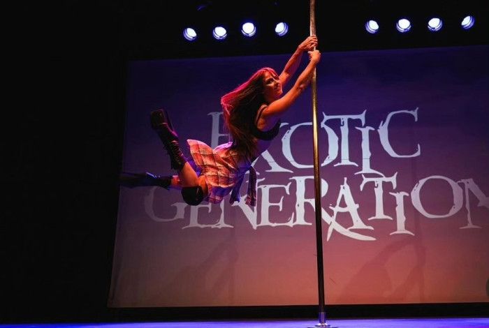 A lady swinging on a pole