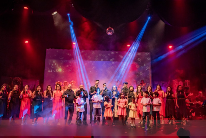 crowd on stage in front of fog with lights