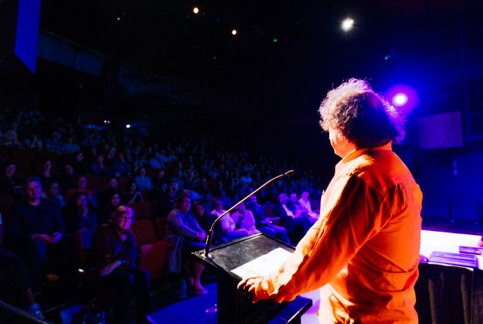Person addressing Drum audience.