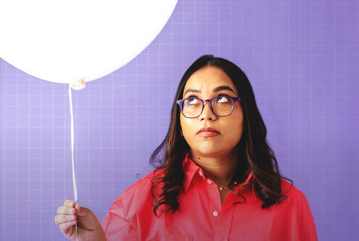 A person holding a white ballon