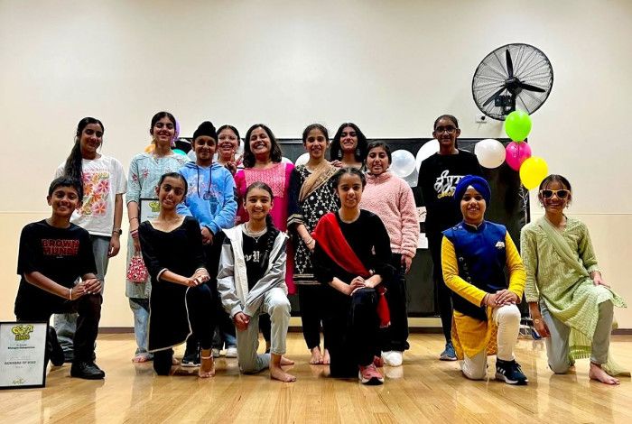 group of young people smiling in dance studio