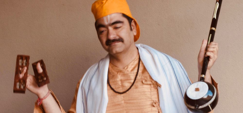 Man in traditional attire playing traditional hindi instruments