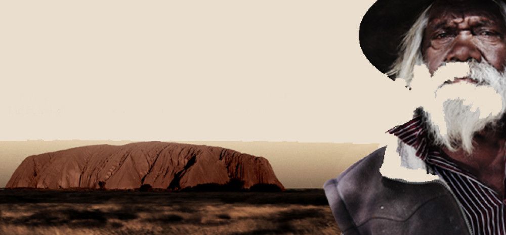 A man with Uluru in the background