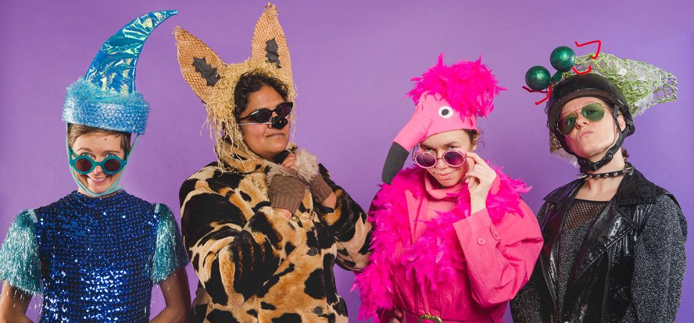 Four people dressed in customes