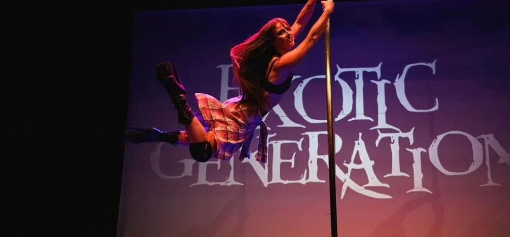 A lady swinging on a pole