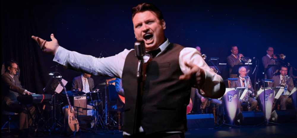 Person singing passionately in from of big band