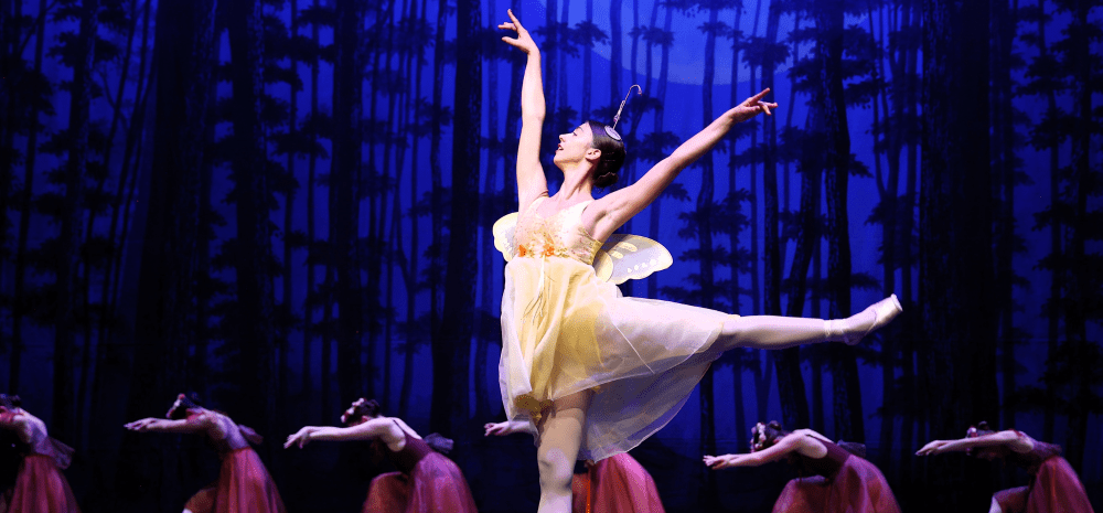 A Ballet Dancer on center stage with back up dancers
