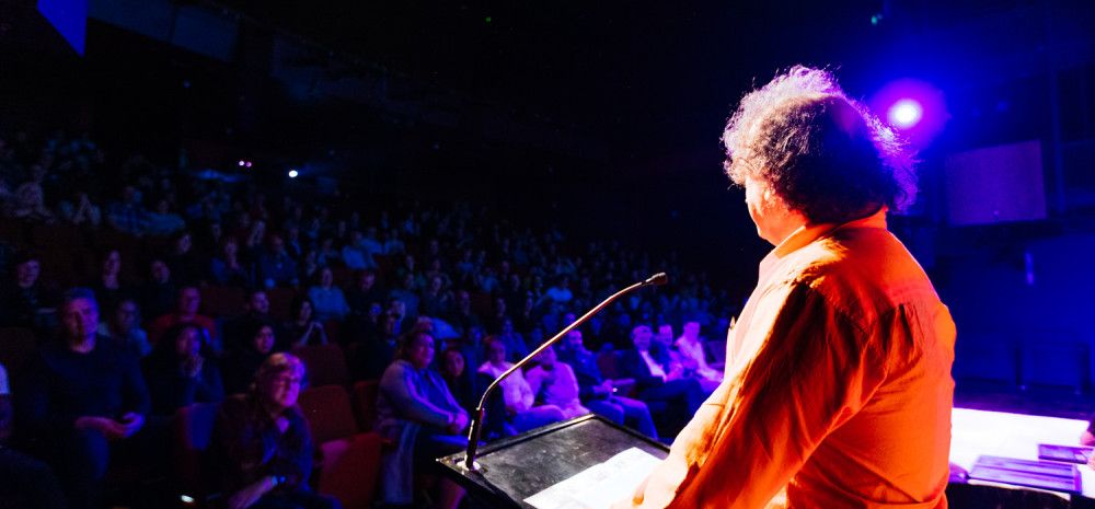 Person addressing Drum audience.