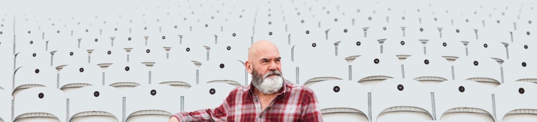 A man sitting on stadium seats