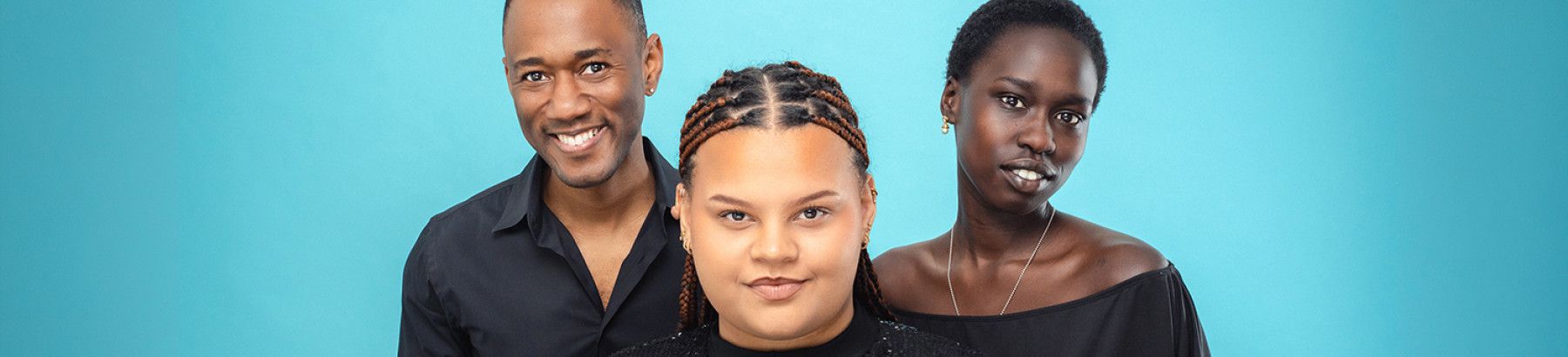 Two women and a man smiling
